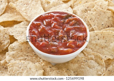 Close up image of bowl of salsa dip with tortilla chips