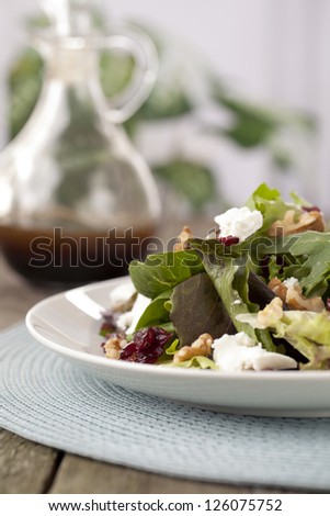 Cropped plate of salad with Worcestershire Sauce bottle at the background