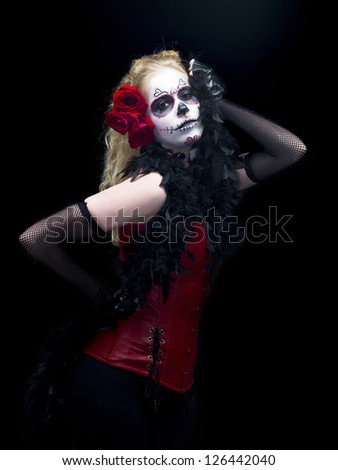 Portrait of a scary woman wearing traditional folk art over black background.