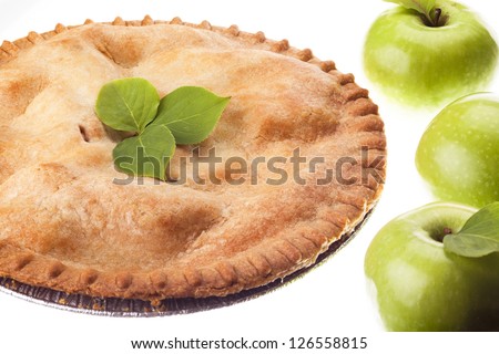 Close-up of apple pie with three green apples.