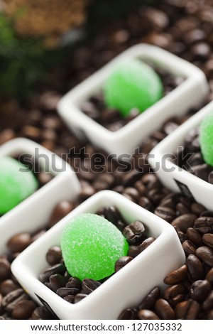 Coffee beans with jelly candies on a dish