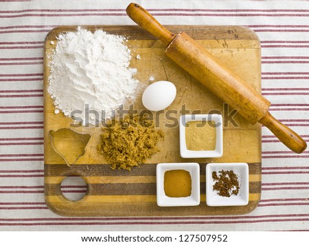 Close-up overhead view of cake ingredient and rolling pin on wooden kitchen worktop
