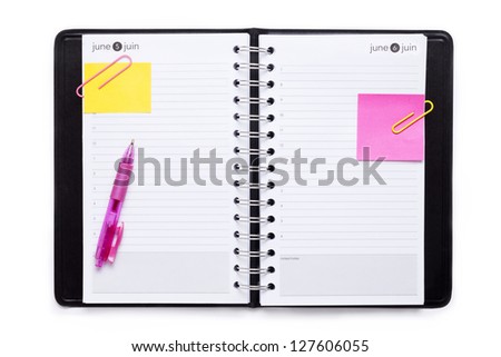 Stationery notebook with pink ballpen and adhesive paper