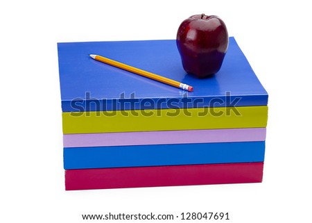 Apple fruit and pencil on top of books indicating food for thought.