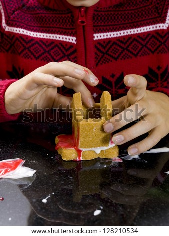 Cropped detailed view of as boy making gingerbread house, Model: Josh Chapman