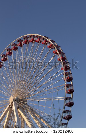 Low angle cropped image of giant wheel against clear sky.