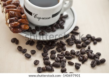 Coffee and almond bar with coffee beans on a saucer