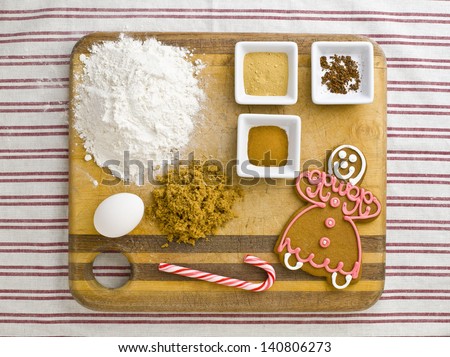 Close-up overhead view of cake ingredient with candy cane and gingerbread.