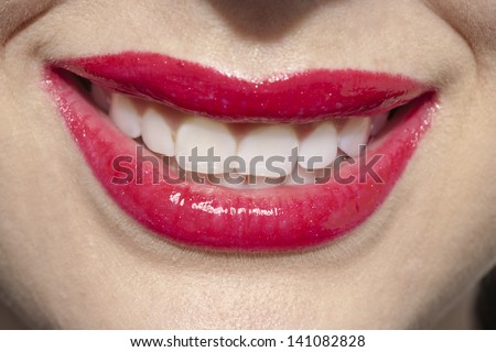 Close up image of red female lips with toothy smile