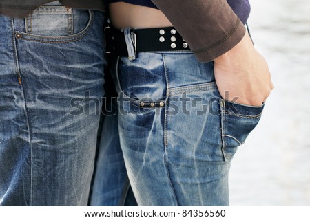 Couple in love, two young people, boy and girl, close together in Jeans.