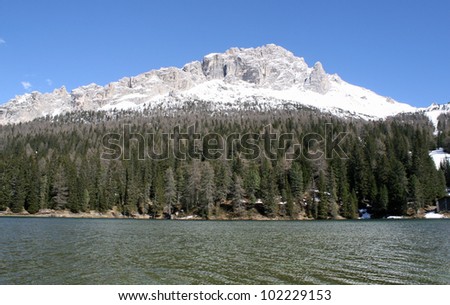 bright and beautiful alpine lake Misurina with dolomiti mountains in the background