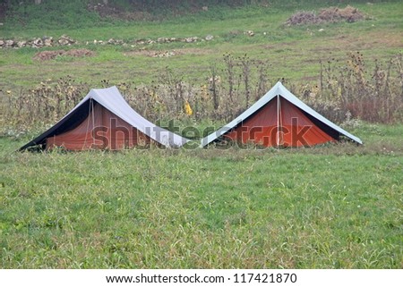 two boy scouts tents planted in the middle of the Hill in autumn