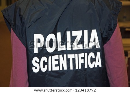 italian scientific policeman with the jacket with reflective writing