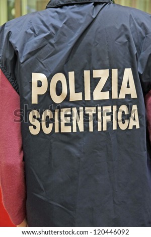 italian scientific police policeman with the jacket with reflective writing