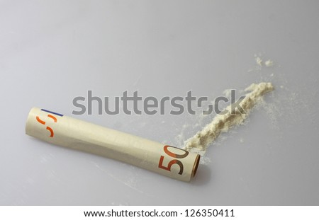 strip of white powder drug and a fifty euro rolled up ready to use