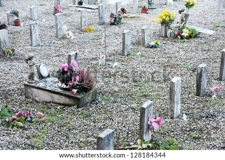 sad grave of a young child died and other sad gravestones on small tombs
