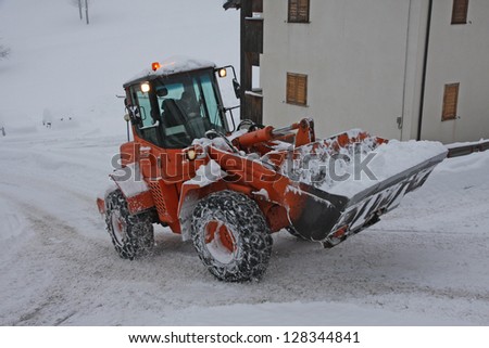 snow plough scraper with the bucket to remove all the snow from the road