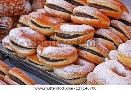 kraffen stuffed with chocolate and cream and other cakes and pastries for sale at the market