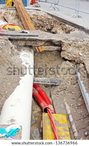 digging for roadworks during the laying of a conduit for fiber optic and electric cables