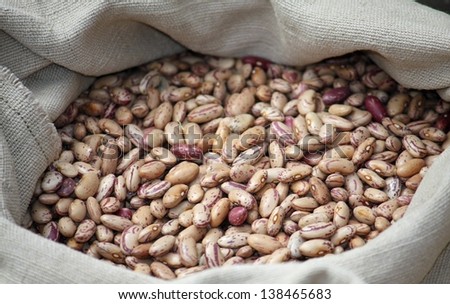 dried beans in a jute bag for sale at vegetable market