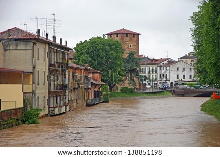 houses near the shore of the raging river during the flood