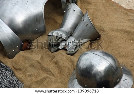 gloves and metal armor with a helmet during the medieval spectacle