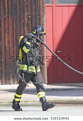 brave firefighters with oxygen tank fire during an exercise held to extinguish the fire in a House