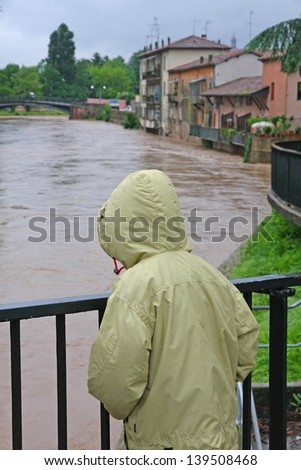 young child with waterproof watch with dismay the growing river level