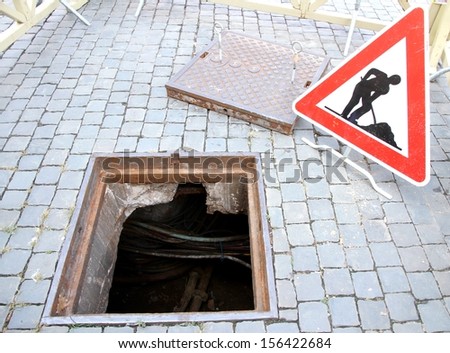 manhole opened for excavation and repair the cable and the signal of caution work in progress