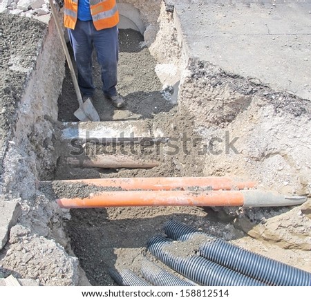 laying of optical fiber and electric cables in a roadworks and a worker 2
