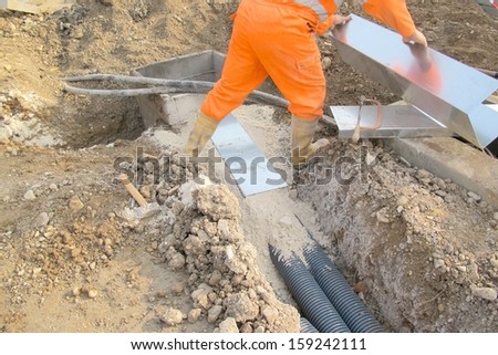 working with work overalls in the excavation of electrical construction