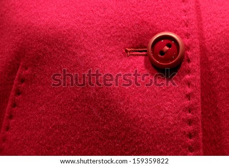 stylish coat with red button and sewn by hand stitching