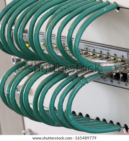 detail of connection of the Green network cables in a firewall and integrated switch to connect the computers to the internet