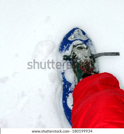 blue snow shoes for walking on soft snow mountain with red snow suit