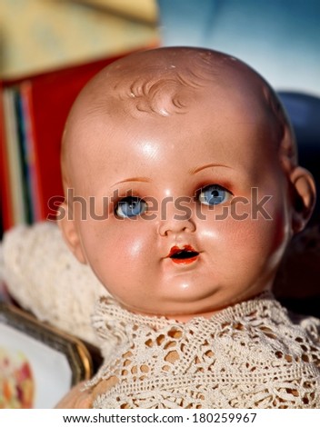 face of an old 1920s vintage doll for sale in antiques shop