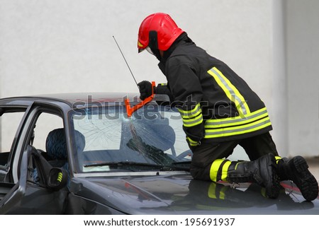 brave Fire Chief breaks the windshield of the car with a special hammer