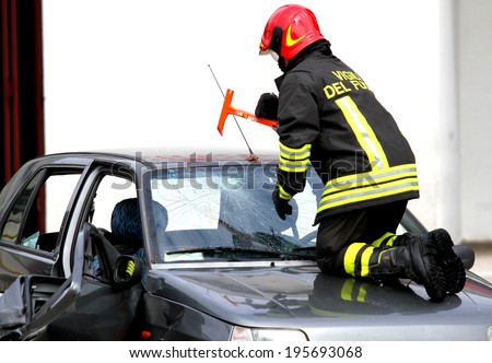 Fire Chief breaks the windshield of the car with a special hammer