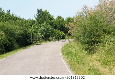 curve of a paved road and you don\'t know what there is behind the curve
