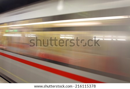 fast underground subway train while hurtling fast with commuters on board