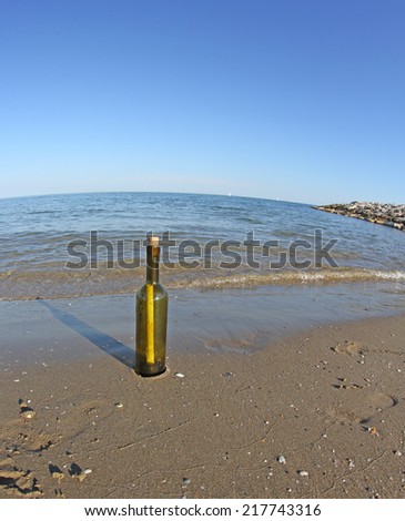 glass bottle with a secret message on the shore of beach