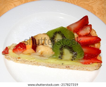 slice of fruit cake with red strawberries and green  kiwi