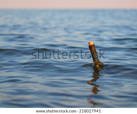 glass bottle with a secret message in the middle of the ocean