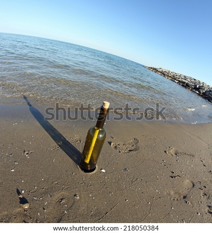 bottle with a secret message on the shore of sandy beach