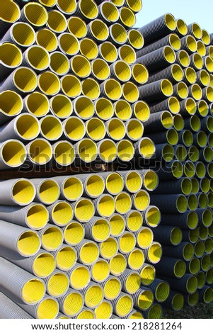 many yellow corrugated pipes for laying electric cables and optical fibers
