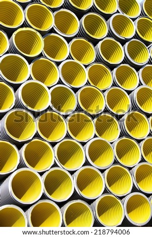 background of yellow corrugated pipes for laying electric cables and optical fibers