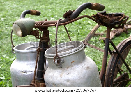 old milkman bike with two old aluminum cans for the transport of milk and broken saddle
