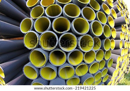 yellow corrugated pipes in a roadworks for laying optical fiber for telecommunications