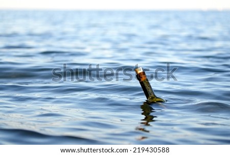glass bottle with a secret message in the middle of the ocean