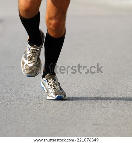 fast runner with sneakers during the Marathon on road