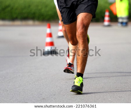 Marathoner runs very fast for the paved road in the final sprint to the finish line first